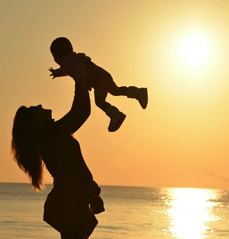 silhouette of a mother carrying a child.